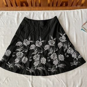 Loft black skirt with embroidered white flowers.